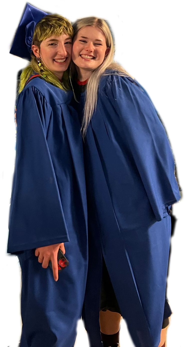 Me and my friend posed in graduation gowns circa 2021